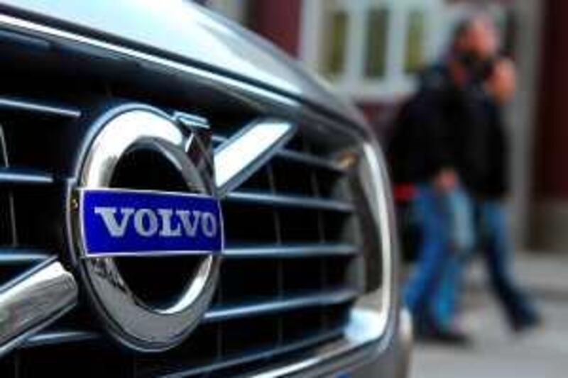 People walk past a Volvo S80L parked in Beijing on April 1, 2010. Chinese carmaker Zhejiang Geely Holding hopes to use its takeover of Volvo to crack China's fast-growing luxury car market and vault into global contention using the Swedish brand's cutting-edge technology, analysts say. AFP PHOTO/Frederic J. BROWN *** Local Caption ***  211498-01-08.jpg *** Local Caption ***  211498-01-08.jpg