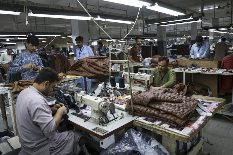 Workers sew leather jackets, in Sialkot, Pakistan. The UAE plans to invest $1bn across various sectors of the Pakistani Economy. Bloomberg