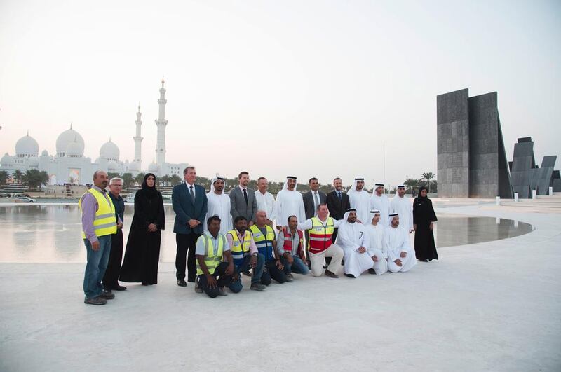 Sheikh Mohammed stands for a photograph with staff involved with the design and construction of the Oasis of Dignity. Hamad Al Kaabi for the Crown Prince Court — Abu Dhabi