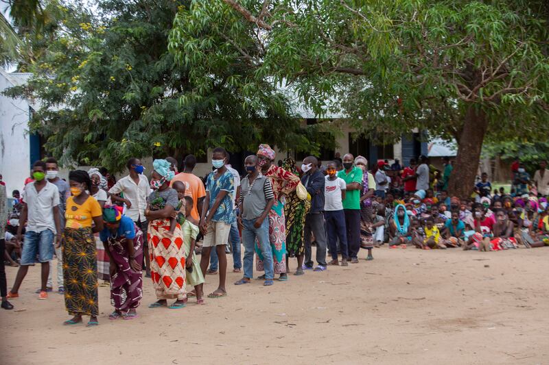 Some of the thousands of people displaced by fighting in northern Mozambique queue at a UN centre for aid. AFP