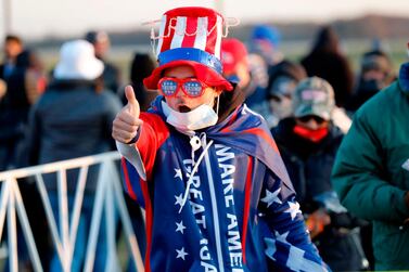 A supporter of US President Donald Trump gives a thumb's up as he arrives to attend his final Make America Great Again rally of the 2020 US Presidential campaign at Gerald R. Ford International Airport on November 2, 2020, in Grand Rapids, Michigan. / AFP / JEFF KOWALSKY