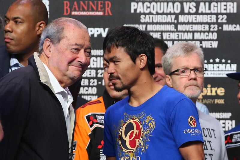 Top Rank Founder and CEO Bob Arum, Manny Pacquiao and trainer Freddie Roach talk during a 2014 weigh-in at The Venetian in Macau. Chris Hyde / Getty Images file