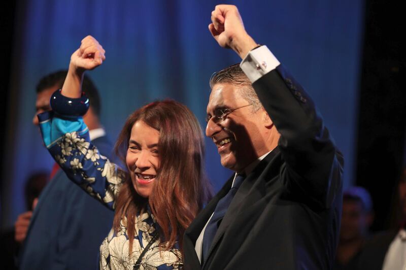 Tunisian presidential candidate Nabil Karoui and his wife gesture to his supporters at rally on the last day of campaigning before the second round of the presidential elections, in Tunis, Tunisia. AP