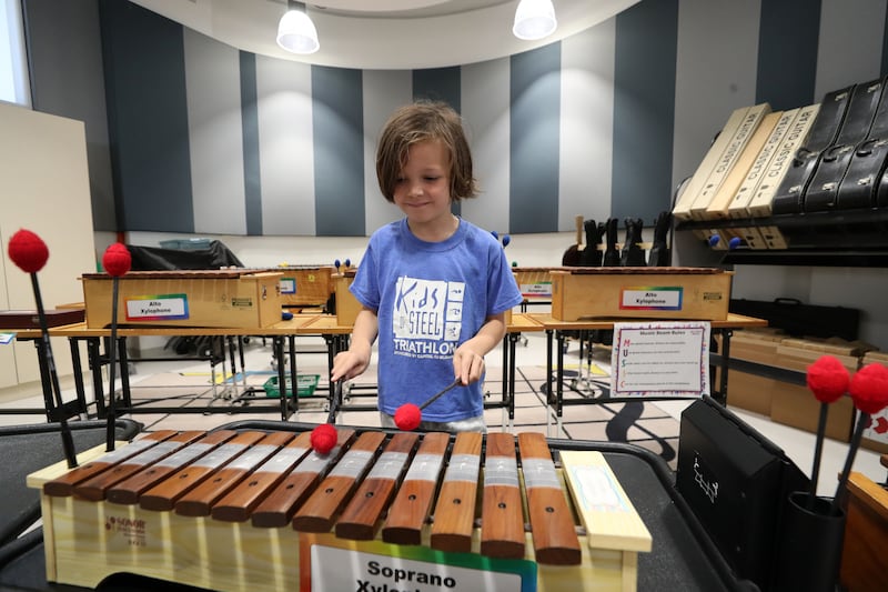 A pupil explores the elementary school music room at the emirate's only American non-profit community school