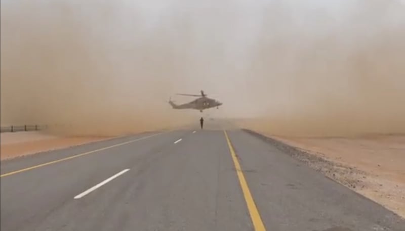A helicopter lands on an empty stretch of motorway between the towns of Adam and Haima to collect a critically injured person. Photo: Royal Oman Police
