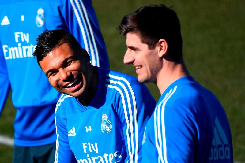Real Madrid's Brazilian midfielder Casemiro, left, laughs with Belgian goalkeeper Thibaut Courtois. AFP