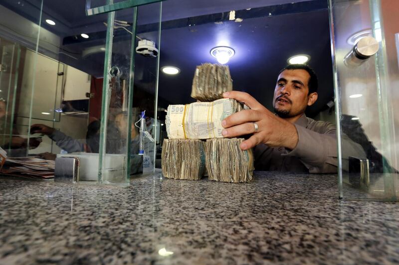 epa06990494 A Yemeni man holds Yemeni currency banknotes amid a continuous collapse of the Rial currency, at a currency exchange office in Sanaâ€™a, Yemen, 01 September 2018. According to reports, the Yemeni currency Rial has lost more than 100 percent in value against the US dollar where the exchange rate of the YR against one dollar amounted to about 600 YR compared to 250 YR at the beginning of the over three-year conflict in the Arab world's poorest country.  EPA/YAHYA ARHAB