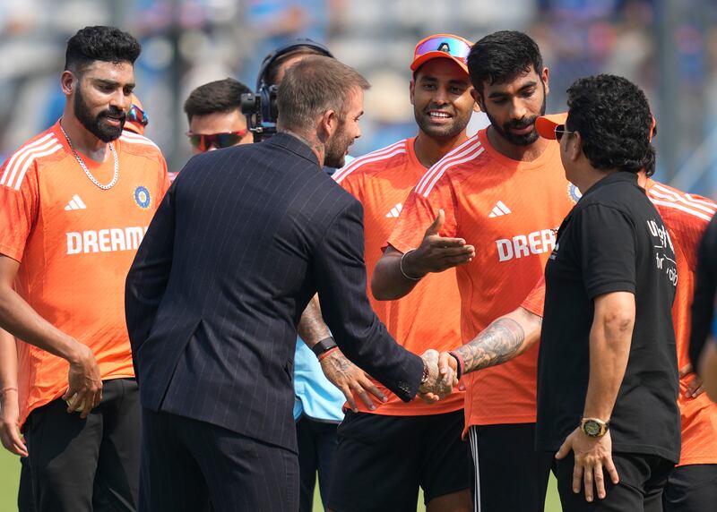 David Beckham and Sachin Tendulkar talk to Indian players at the Wankhede Stadium. AP