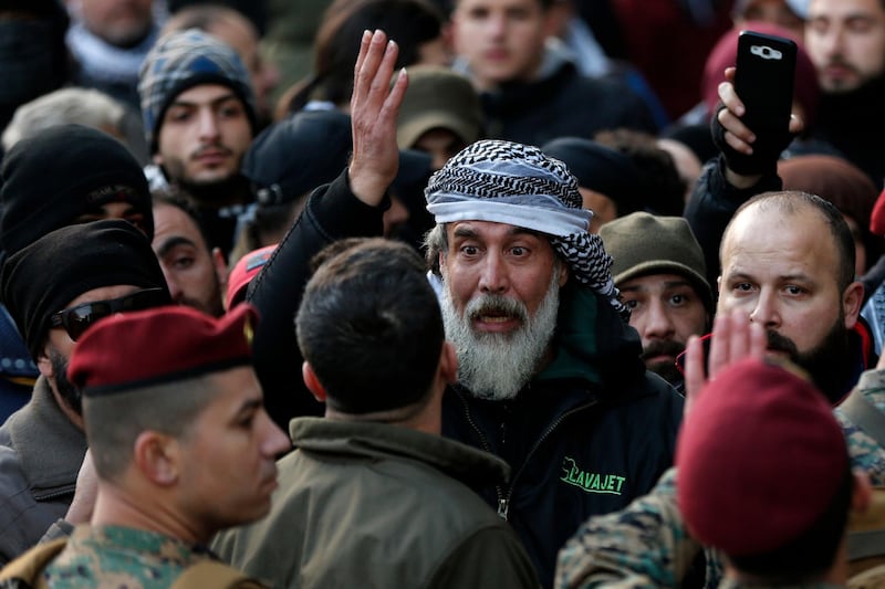 An anti-government protester argues with Lebanese army special forces. AP Photo