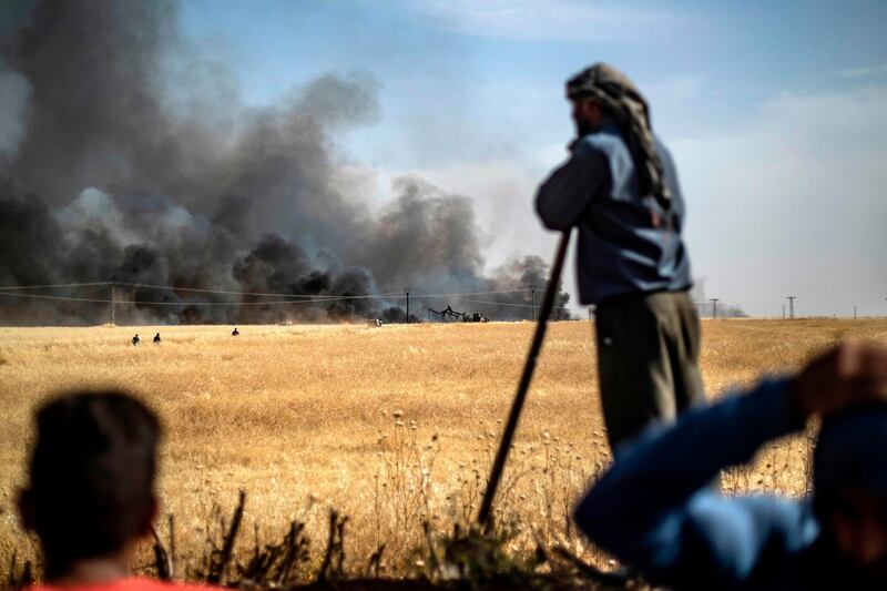 People battle a blaze in an agricultural field in the town of al-Qahtaniyah, in the Hasakeh province near the Syrian-Turkish border on June 10, 2019. Fires have erupted in various parts of Syria in recent weeks, with all sides blaming each other for starting them.
In the Kurdish-run breadbasket province of Hasakeh, of which Al-Qahtaniya is part, IS has claimed several arson attacks on wheat fields.  / AFP / Delil souleiman
