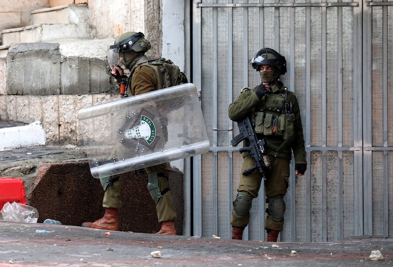 Israeli soldiers with riot gear during clashes with Palestinians in Hebron. EPA