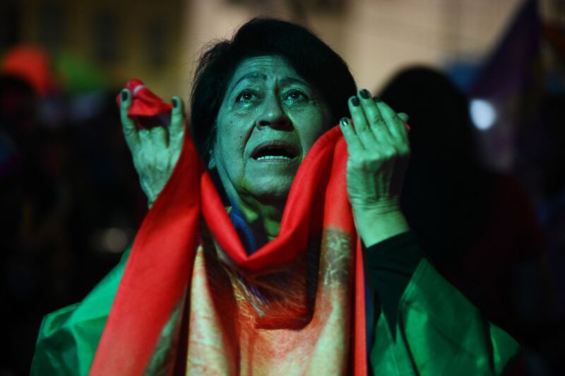 A Lula supporter watches the vote, in Rio de Janeiro, Brazil. The result was much tighter than expected, after numerous polls had put the left-wing candidate well ahead. AFP