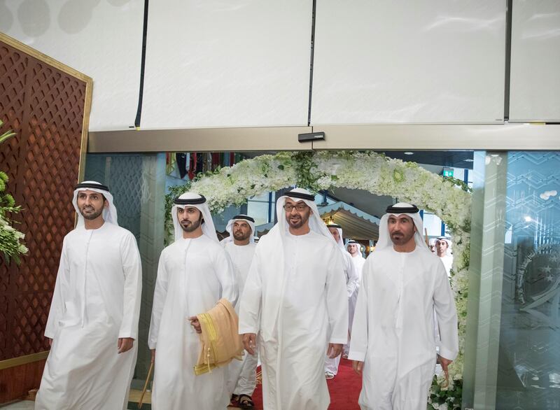 ABU DHABI, UNITED ARAB EMIRATES - July 18, 2017: HH Sheikh Mohamed bin Zayed Al Nahyan Crown Prince of Abu Dhabi Deputy Supreme Commander of the UAE Armed Forces (2nd R) attends the wedding reception of Saeed Juma Al Ghuwais (3rd R), at Armed Forces Officers Club. Seen with Juma Al Ghuwais (R).

( Mohamed Al Hammadi / Crown Prince Court - Abu Dhabi )
---