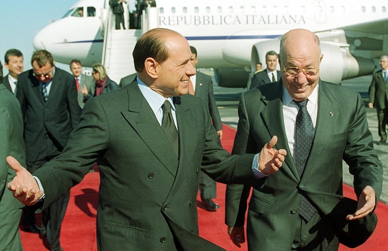 Mr Berlusconi is welcomed by former Tunisian presidential adviser Abdelaziz Ben Dhia, right, in Tunis in November 2001. It was his first official visit to a Muslim country after he said the West 'should be confident of the superiority of our civilization'. AFP 