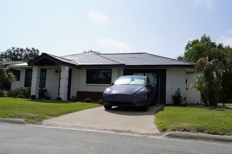 A Tesla charges in the driveway of a home in Boca Chica.