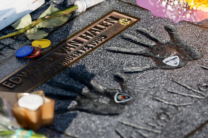 Flowers, candles and guitar picks sit next to Eddie Van Halen's hand prints on Hollywood's Rock Walk in Hollywood, California. EPA