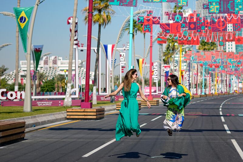 Brazil fans jump for joy on Doha Corniche in Qatar. AP