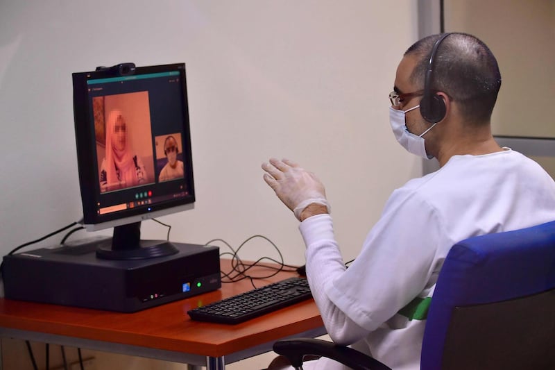 An inmate chats to a relative in a video call