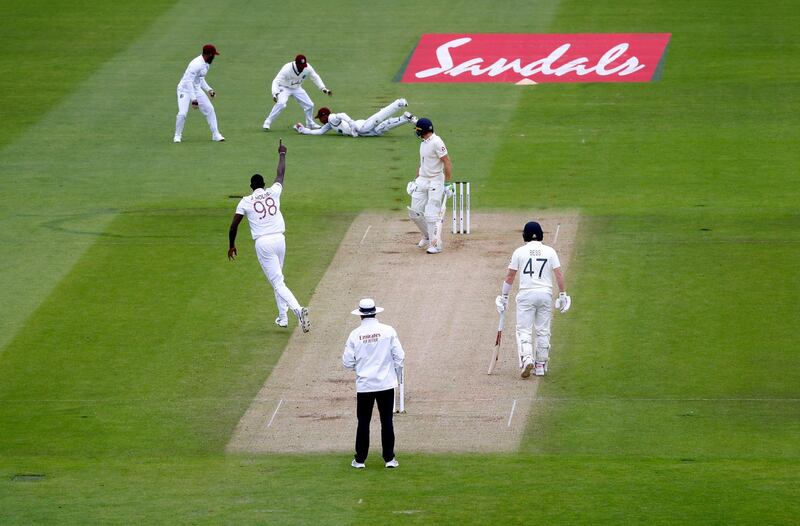 West Indies' captain Jason Holder celebrates taking the wicket of England batsman Jos Buttler. AP