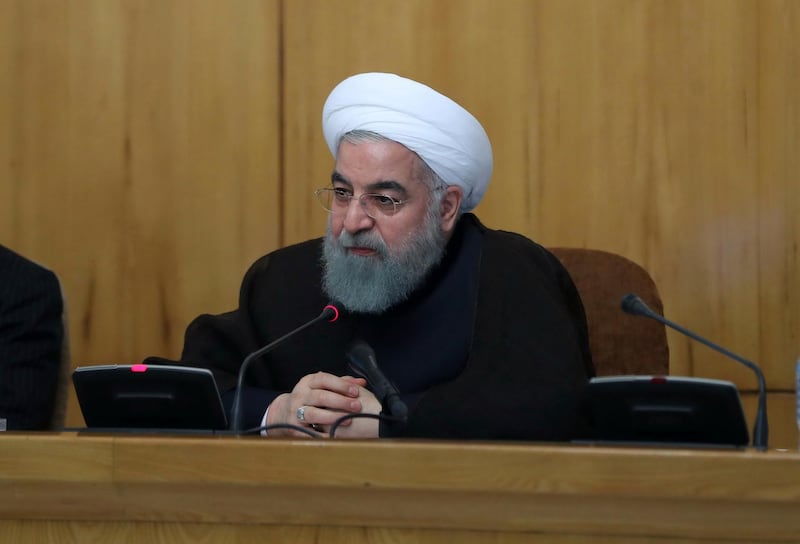 In this photo released by official website of the office of the Iranian Presidency, Iran's President Hassan Rouhani speaks in a cabinet meeting in Tehran, Iran, Wednesday, July 26, 2017. Iran's President Hassan Rouhani says his country will respond if U.S. legislation imposing sanctions on people involved in Iran's ballistic missile program becomes law. (Iranian Presidency Office via AP)