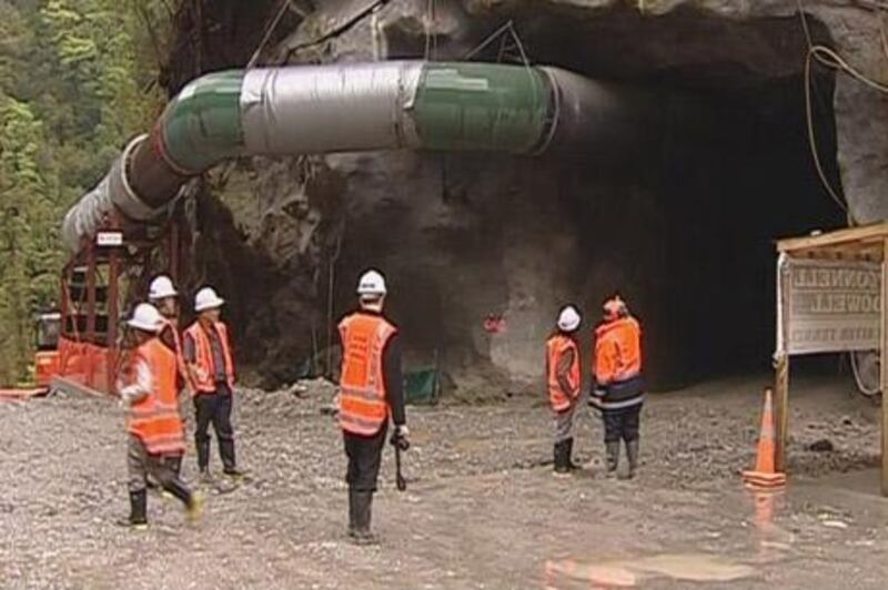 Miners stand near the entrance of a remote colliery mine in this still image taken from video at Grey District, New Zealand, November 19, 2010. An explosion rocked a  remote colliery in New Zealand on Friday, trapping 27 miners underground, the company and local authorities said. The new mine, which only began shipping coal this year, is dug into the side of a mountain range in the country's rugged South Island, burrowing into a deposit that, according to one recent visitor, was relatively gaseous. Peter Whittall, chief executive of the mine's owner, Pike River Coal said he believed 27 miners were trapped.  REUTERS/TVNZ via Reuters TV (NEW ZEALAND - Tags: DISASTER IMAGES OF THE DAY) TEMPLATE OUT. AUSTRALIA OUT. NO COMMERCIAL OR EDITORIAL SALES IN AUSTRALIA. NEW ZEALAND OUT. NO COMMERCIAL OR EDITORIAL SALES IN NEW ZEALAND