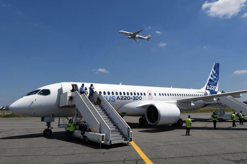 (FILES) A file photo taken on July 10, 2018 shows the new Airbus A220-300 parked on the tarmac at the Airbus delivery center, in Colomiers southwestern France.  
 The European aircraft manufacturer Airbus announced on Januray 3, 2019 the finalization of two orders of 60 A220-300 plane each, for an amount of 11 billion dollars (9.7 billion euros). / AFP / PASCAL PAVANI
