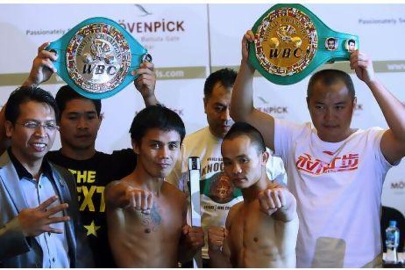Dubai, United Arab Emirates- June, 27, 2013: (L) Philippines Boxer Denver Cuello and (R) Chinese Boxer Xiong Zhao Zhong pose during the official Weigh-In in Dubai. ( Satish Kumar / The National ) For Sports