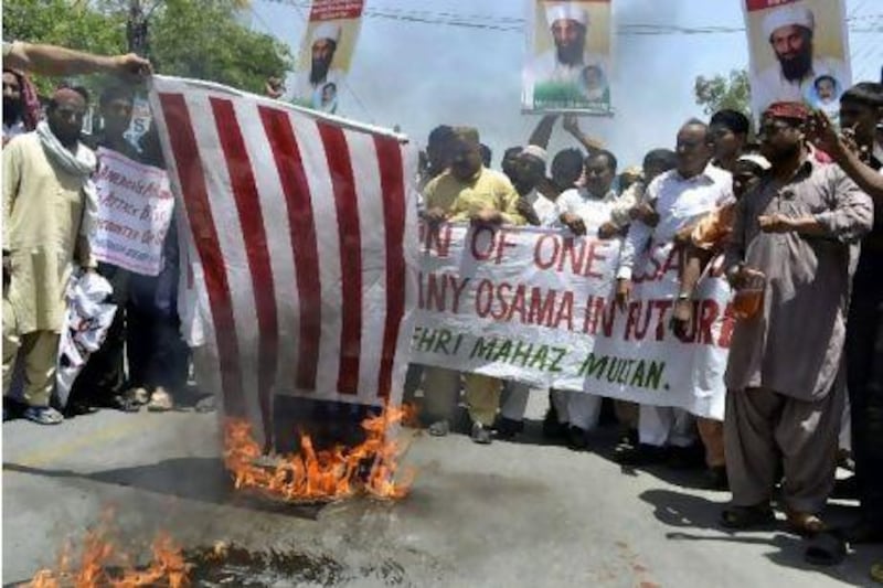 Pakistani demonstrators burn a US flag during a protest in Multan against the killing of the al Qa'eda leader Osama bin Laden.