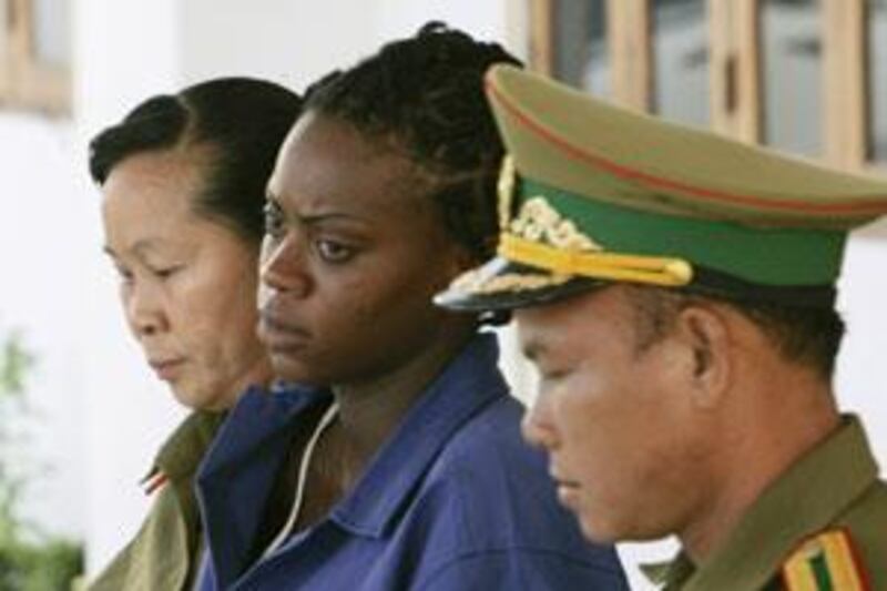 Samantha Orobator, centre, leaves Vientiane Capital Court in Vientiane, Laos.