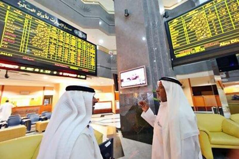 MSCI upgraded the UAE and Qatar to emerging markets status last month. Above, investors monitor trading at the Abu Dhabi Securities Exchange. Ben Job / Reuters