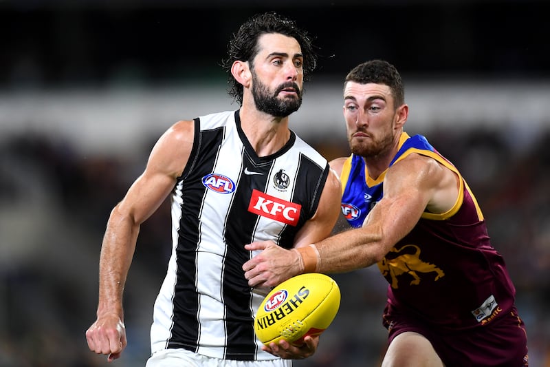 Brodie Grundy of the Magpies handballs during the AFL match against Brisbane Lions at The Gabba on April 14, 2022 in Brisbane, Australia. Getty