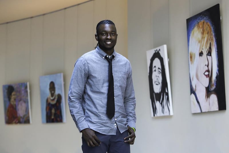 Artist Victor Sitali poses with his artworks. Photo: Victor Sitali