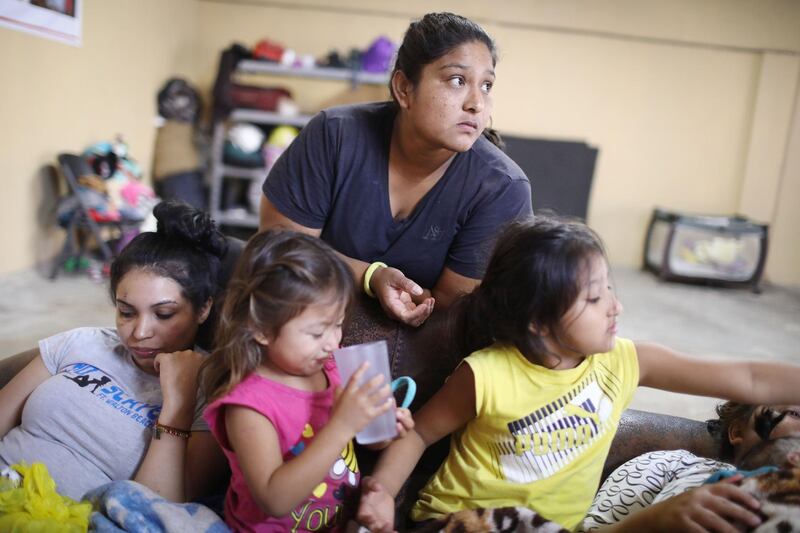 TIJUANA, MEXICO - JUNE 20:  A migrant mother (TOP C), who is waiting to seek asylum for herself and her two daughters (LOWER C and R) in the U.S., gathers with another migrant (L) in a shelter for migrant women and children on June 20, 2018 in Tijuana, Mexico. The mother, who did not wish to give their names, said they were fleeing their hometown near the Pacific coast of Mexico after a violent carjacking of her taxicab. The Trump Administration's controversial zero tolerance immigration policy led to an increase in the number of migrant children who have been separated from their families at the southern U.S. border. U.S. Attorney General Jeff Sessions has added that domestic and gang violence in immigrants' country of origin would no longer qualify them for political asylum status.  (Photo by Mario Tama/Getty Images)