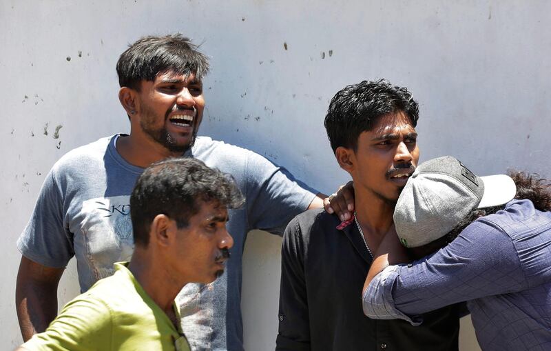 Relatives of a blast victim weep outside a police morgue in Colombo. AP