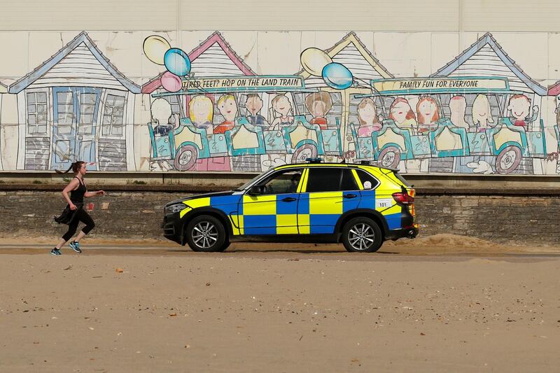 Police are seen on Bournemouth beach, Bournemouth, UK on April 5, 2020. Reuters