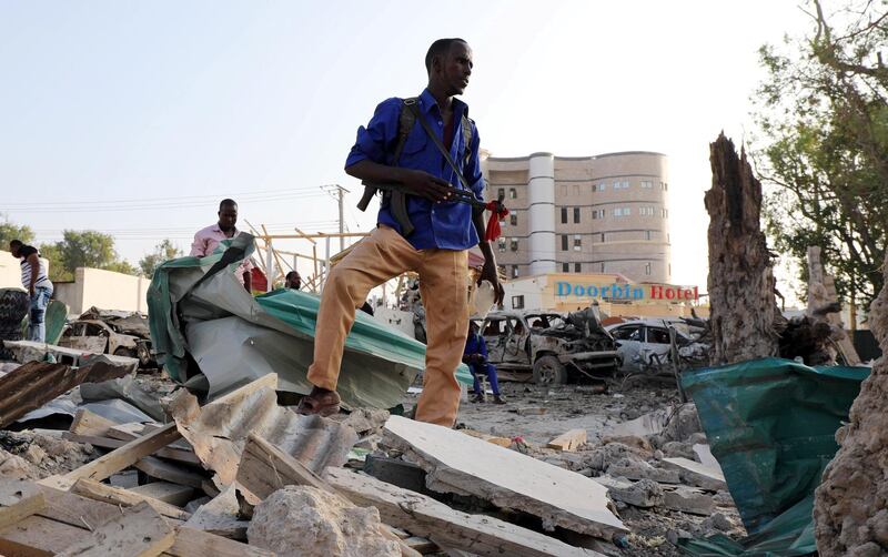 A security officer from Doorbin Hotel assesses the debris after a suicide car explosion in front of the hotel in Mogadishu, Somalia. Feisal Omar / Reuters