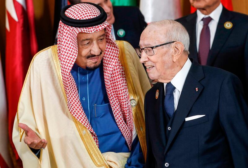 Saudi Arabia's King Salman bin Abdulaziz (left) speaks with Tunisian President Beji Caid Essebsi during the group photo with other Arab leaders during the 30th Arab League summit in the Tunisian capital Tunis.  AFP