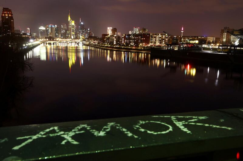 A word reading "Love" is written on a bridge railing with the city's skyline seen in the background, as the spread of Covid-19 continues, in Frankfurt, Germany. Reuters