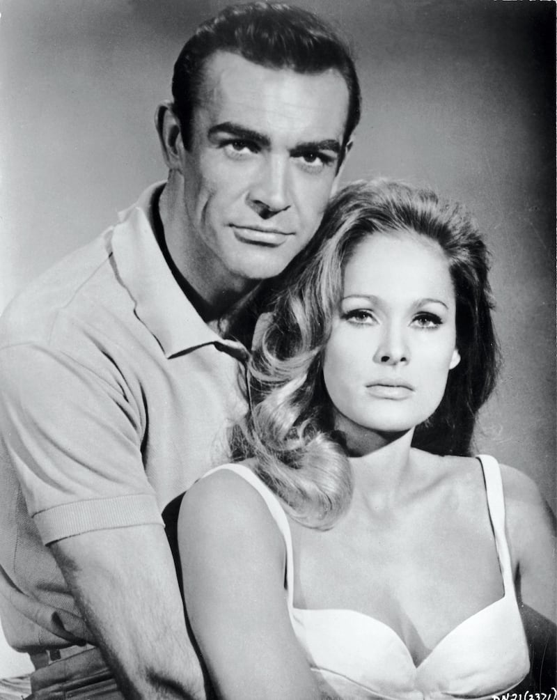 Scottish actor Sean Connery, as fictional secret agent James Bond, and Swiss actress Ursula Andress pose together in a  promotional still for the film 'Dr. No,' directed by Terence Young, 1962. (Photo by MGM Studios/Courtesy of Getty Images)