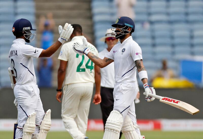 India's cricketer Virat Kohli, right, celebrates his hundred with Ajinkya Rahane. AP