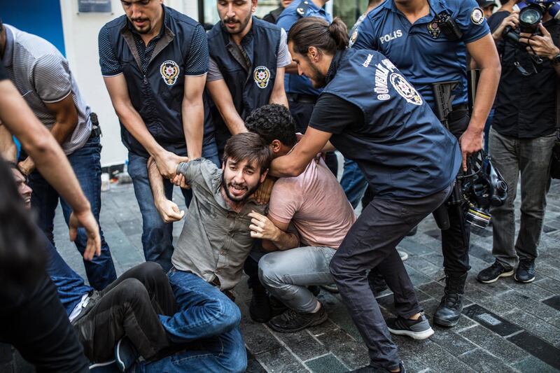 epa06972333 Turkish riot police interfering to Saturday Mothers 700th gathering at Istiklal street in Istanbul, Turkey, 25 August 2018. Mothers are while sits every saturday at Istiklal Street for wives and relatives holding pictures of their relatives and demand clarification for the disappearence of their relatives, who are belived to be arrested, torturted or killed.  EPA/STR