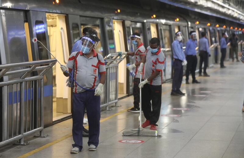 Indian metro workers sanitise a metro station as a precautionary measure for coronavirus in New Delhi, India.  EPA