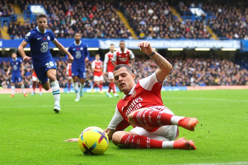 Arsenal's Granit Xhaka slides to try and prevent the ball going out for a throw-in. Reuters
