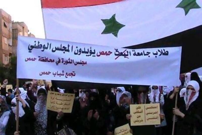 Students protesting against Syria's president Bashar Al Assad march through the streets of Homs last October.