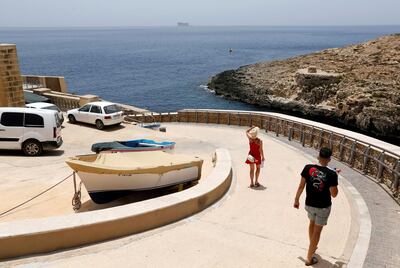 Tourists walk down to the sea in Zurrieq Valley, outside Zurrieq, Malta June 24, 2021. Malta may be one of the countries added to a 'green' list where UK travellers will be able to visit without needing to quarantine after returning from holiday.  REUTERS/Darrin Zammit Lupi