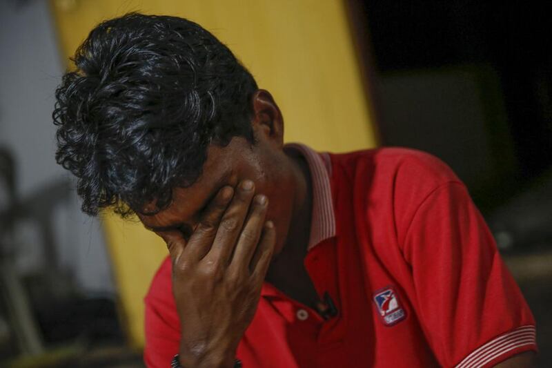 Mohamad Husein, a Rohingya from Myanmar, wipes tears from his eyes as he talks to reporters at his hostel on the outskirts of Alor Setar, Kedah, North Malaysia. After his village in Myanmar's northwest Rakhine had been destroyed in a fire set by a Buddhist mob, he and his younger sister became separated from their family. AP Photo/Vincent Thian