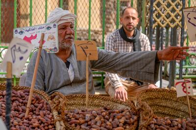 A dates vendor waits for shoppers before the start of Ramadan in Sayyeda Zeinab market in Cairo. AP