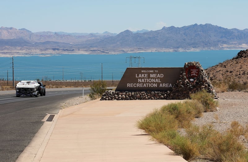 A vehicle towing a boat drives past a sign welcoming visitors to Lake Mead. The water level is at its lowest since  1937. Getty