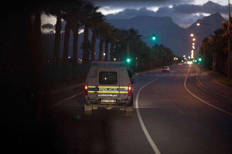 A South African police services van is seen through the window of the ambulance driving in the gang-ridden suburb of Manenberg in Cape Town. Rodger Bosch / AFP / April 14, 2017