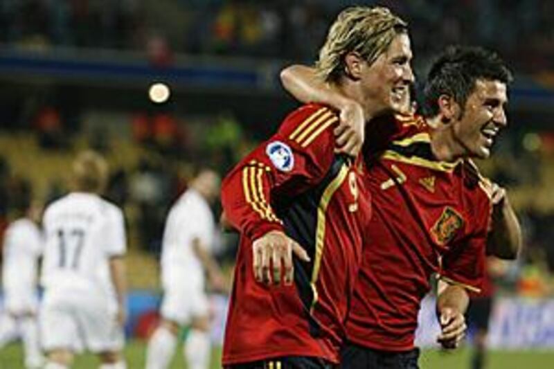 Fernando Torres, left, is hugged by David Villa after he scores his hat-trick goal against New Zealand.